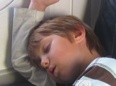 Luc schläft selig im Flugzeug
