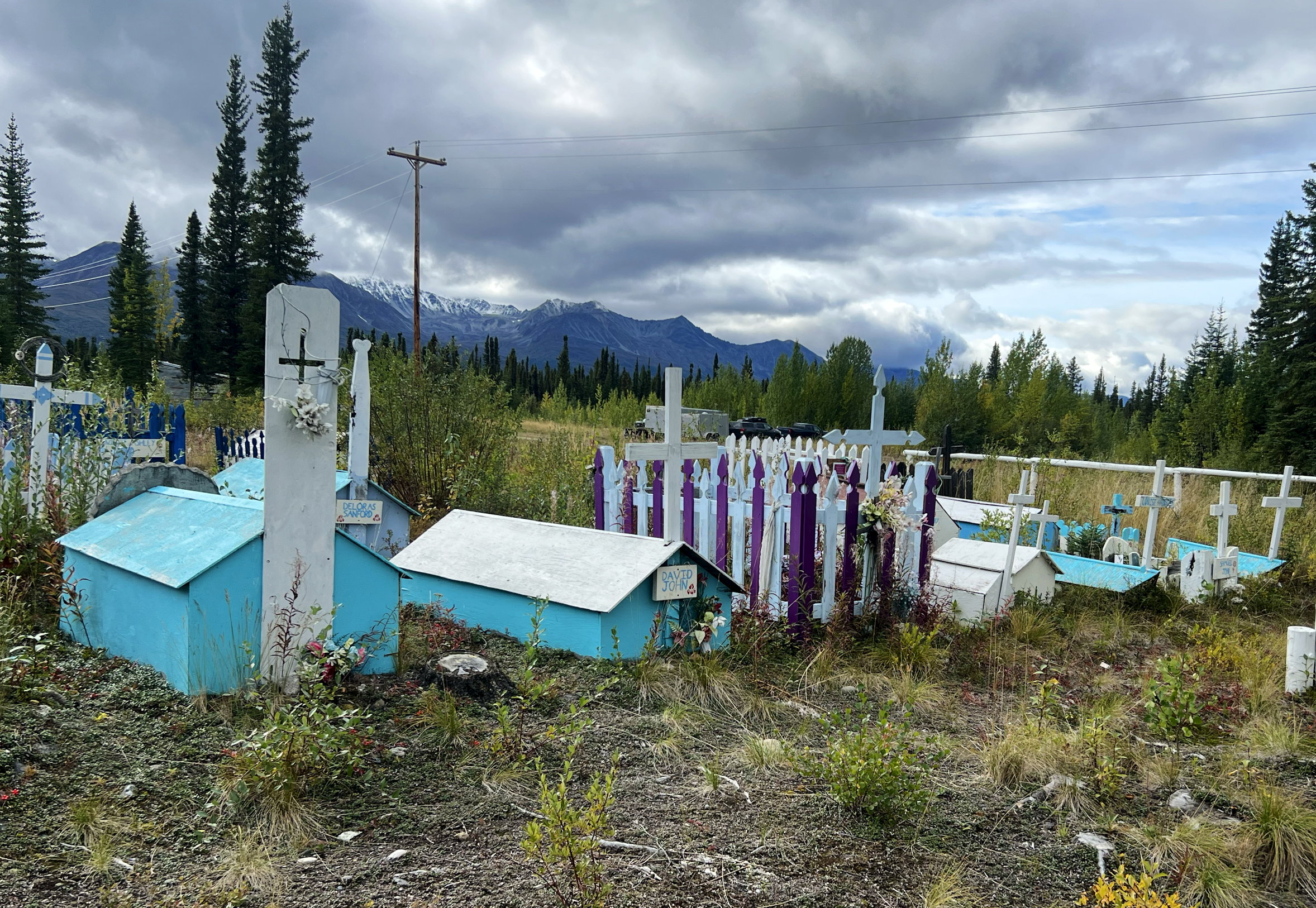 Friedhof in Mentasta Lake, farbige Grabhäuschen aus Holz bedecken die Gräber