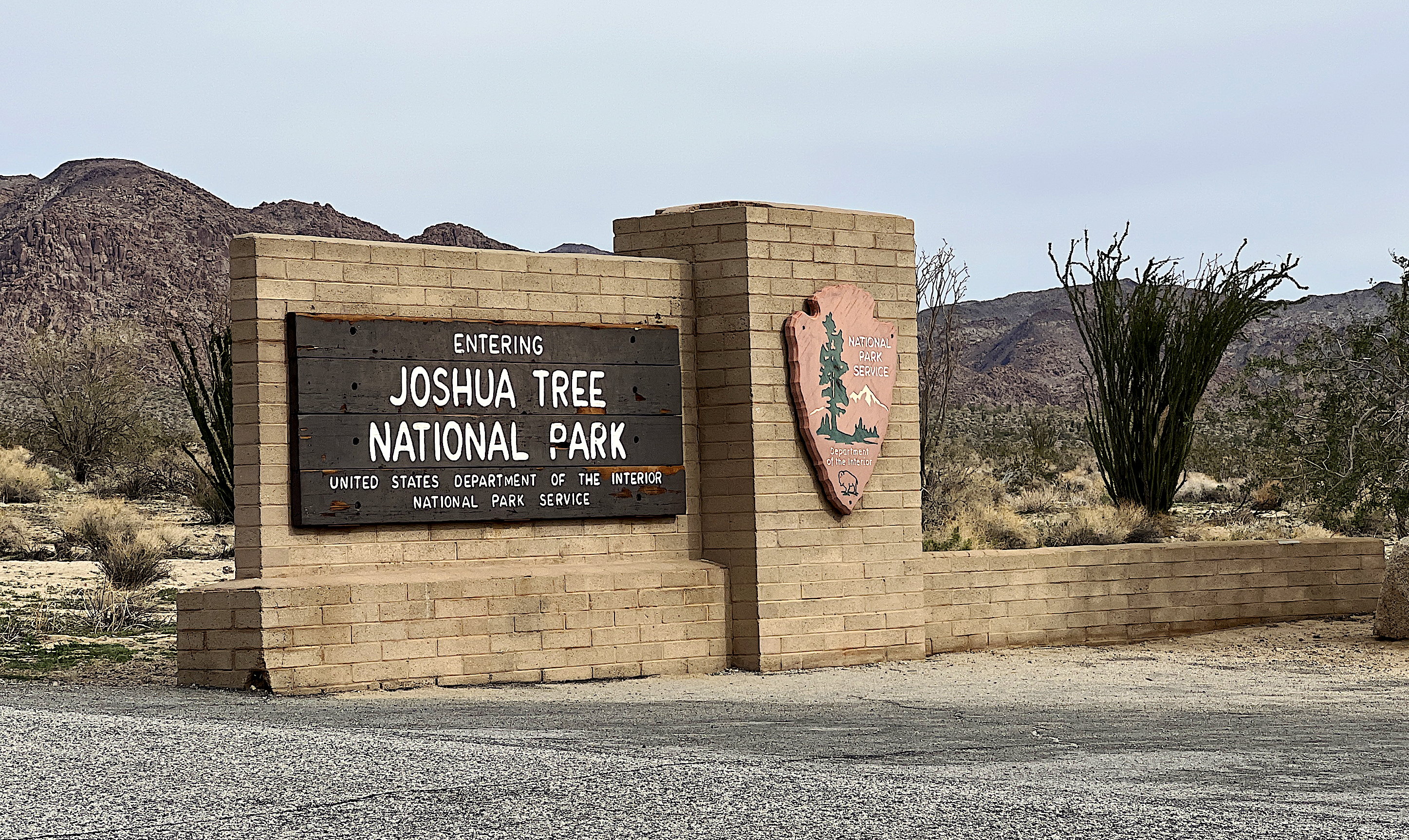 Eine kleine Mauer mit der Aufschrift «Joshua Tree National Park» und dem Wappen/Signet des N.P.S.